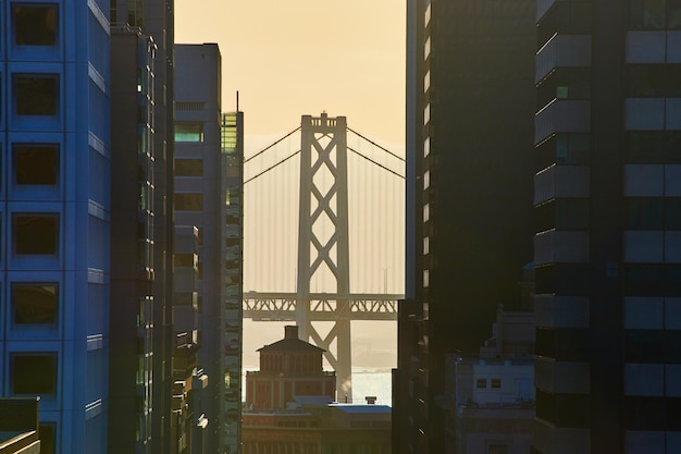 Foto puente de la bahía de san francisco oakland a través de rascacielos