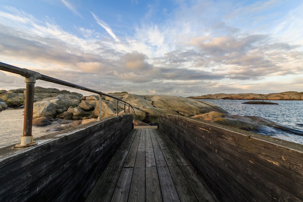 Puente de madera con nubes y cielo arriba