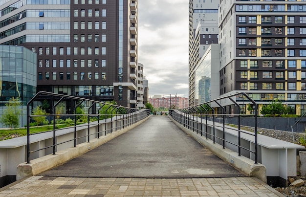 Un puente con una pasarela vallada y un edificio al fondo.