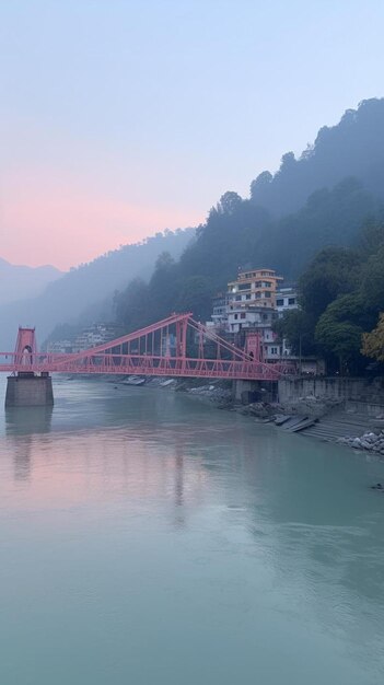 Foto un puente sobre un río con un cielo rosa en el fondo