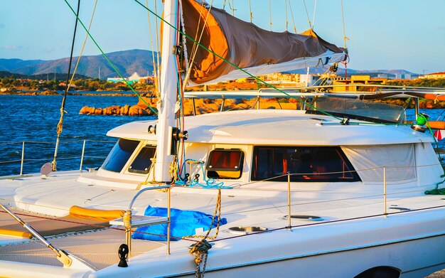 Puerto con barco de lujo en el mar Mediterráneo en la ciudad vieja de Olbia en la isla de Cerdeña en Italia. Yate en la costa italiana de Cerdeña. Técnica mixta.