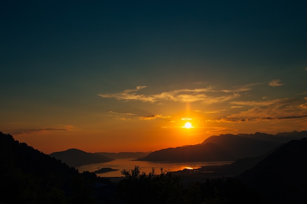 Puesta de sol en montenegro sobre las montañas y el mar