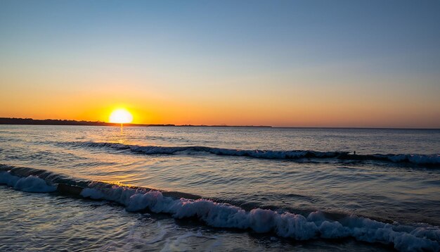 Puesta de sol en la playa con sol amarillo sobre las olas del océano