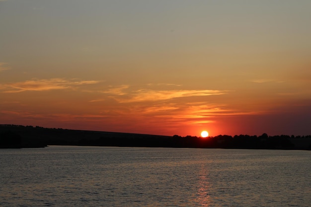 Una puesta de sol sobre un cuerpo de agua.