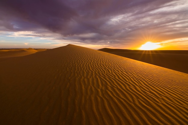 Puesta de sol sobre las dunas de arena en el desierto Paisaje árido del desierto del Sahara