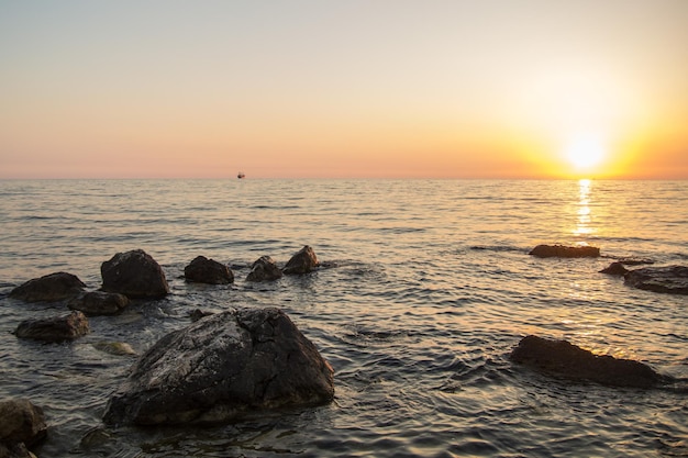 Puesta de sol sobre el mar entre las rocas