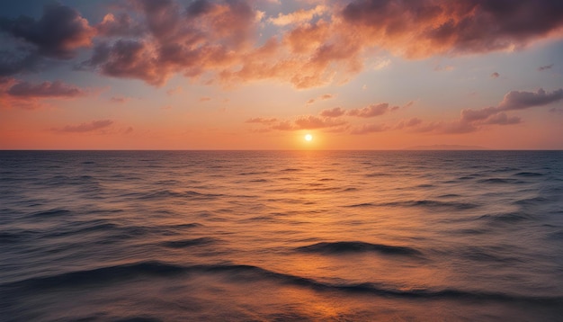 Una puesta de sol sobre el océano con una puesta de sol en el fondo