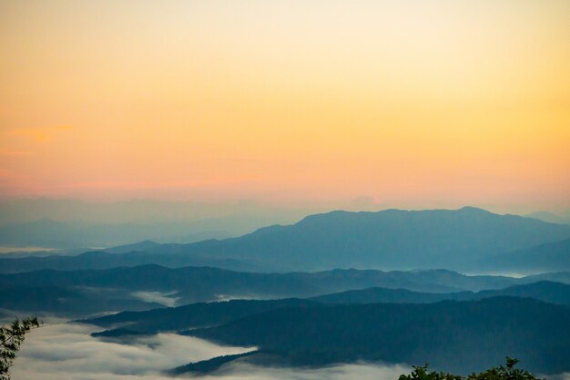 puesta de sol con vistas a las montañas con niebla