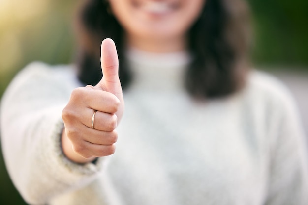 Pulgares arriba y primer plano para el éxito apoyo al aire libre o motivación para ganar logro meta en verano Como sí gesto y persona con emoji para comentarios voto y gracias firmar para la revisión