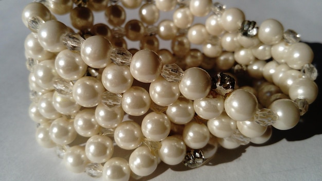 Pulsera de mujer de perlas blancas Luz suave Diseño femenino Fondo blanco