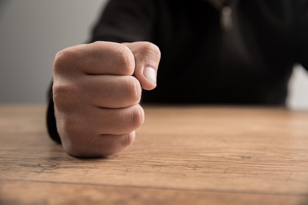 Puños de hombre en una mesa de madera