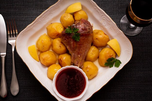 Putenkeule gebacken mit Kartoffeln mit Preiselbeersauce. Leckeres Essen.