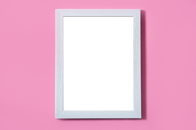 Foto quadro branco em branco sobre fundo rosa