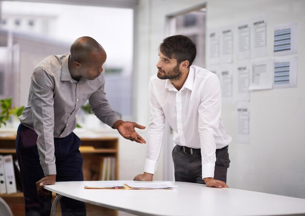 ¿Qué opinas? Foto de dos hombres de negocios discutiendo en una sala de juntas.