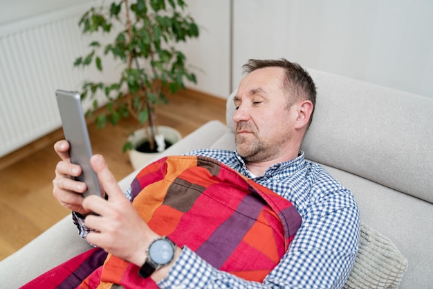 Quédese en casa, lugar de trabajo, hombre que trabaja desde su casa usando tableta coronavirus covid distanciamiento social