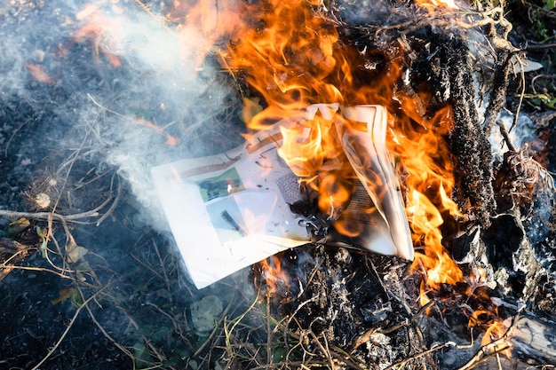 Queimando revista de fotografia em fogo nas hastes