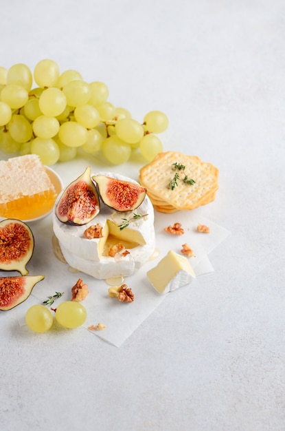 Queso Brie o Camembert con higos, uvas, miel y nueces.