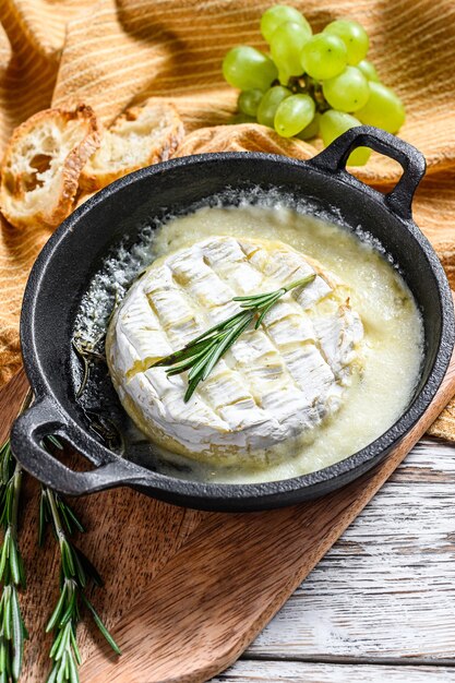 Queso camembert al horno con romero en una sartén