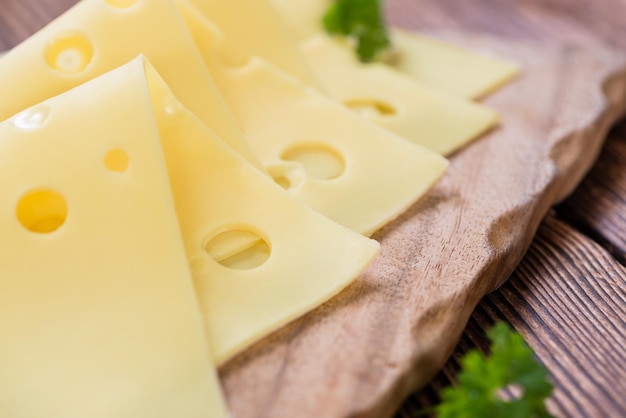 Queso en lonchas sobre fondo de madera