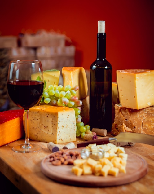 Queso y vino en una mesa oscura.