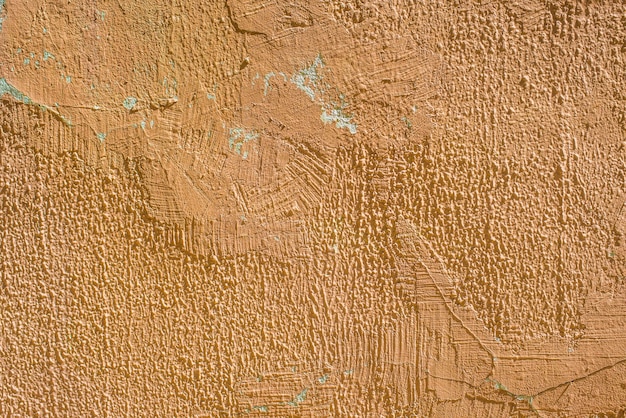 Rachaduras de estuque de parede laranja vermelha velha de fundo de textura