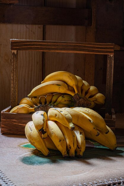 Racimos de plátano en una mesa con toalla bordada