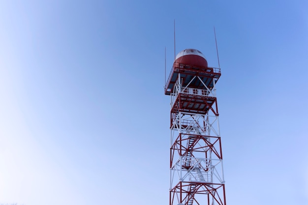 Radar de vigilância meteorológica em uma cúpula protetora esférica, montado em uma torre de treliça, contra o céu