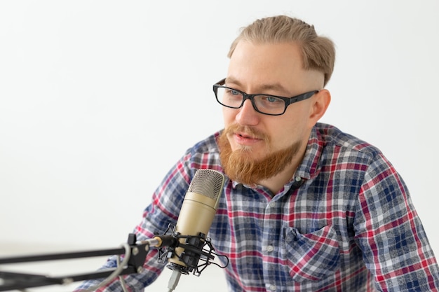 Radio-, DJ-, Blogging- und People-Konzept - Nahaufnahme eines Mannes, der vor Mikrofon sitzt, Moderator im Radio