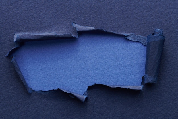 Rahmen aus zerrissenem Papier mit abgerissenen Kanten. Fenster für Text mit Kopierraum. Blaue Farben. Fetzen von Notizbuchseiten. Abstrakter Hintergrund