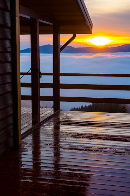 Raios de sol da manhã na varanda de um abrigo turístico nas montanhas