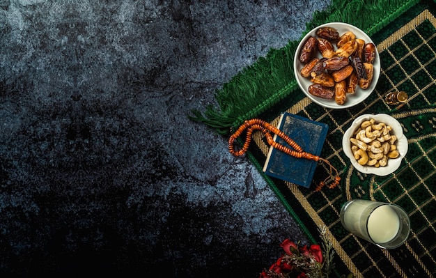 Ramadan concept with Quran prayer beads and dates 
