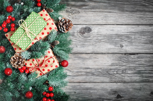 Ramas de abeto y juguetes de Navidad sobre un fondo de madera