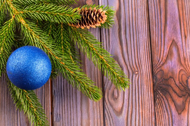 Ramas de un árbol de navidad decorado con bola azul