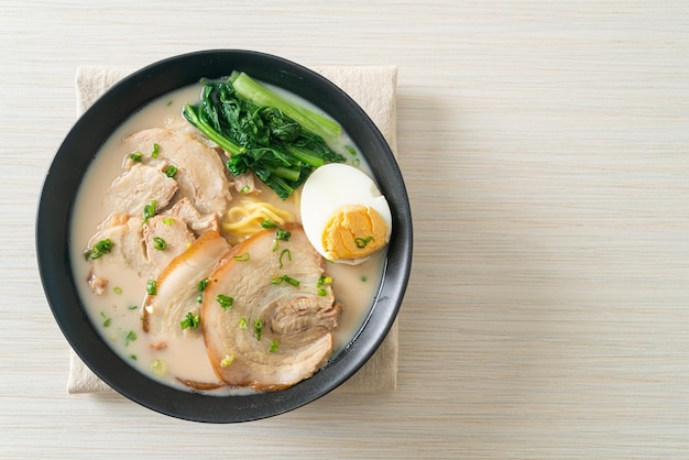 Ramen-Nudeln in Schweineknochensuppe mit gebratenem Schweinefleisch und Ei oder Tonkotsu-Ramen-Nudeln - japanischer Essensstil