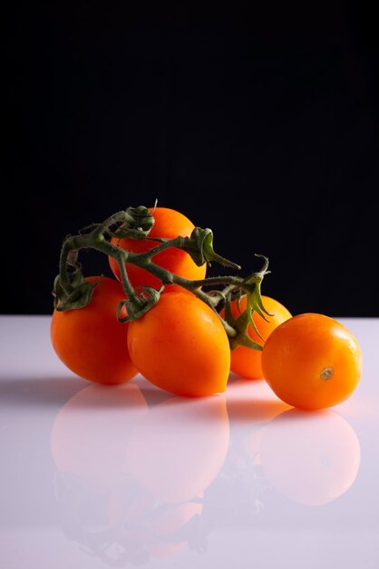 Ramo de tomates vermelhos frescos em fundo preto e branco