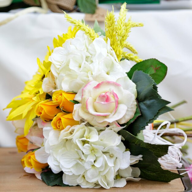 Ramo de flores artificiales sobre una mesa de madera