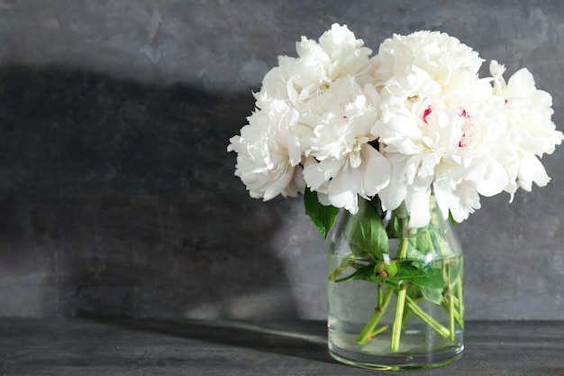 Ramo de hermosas flores de peonía sobre fondo gris