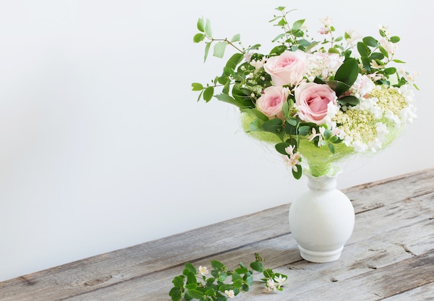 Ramo de rosas en la mesa de madera