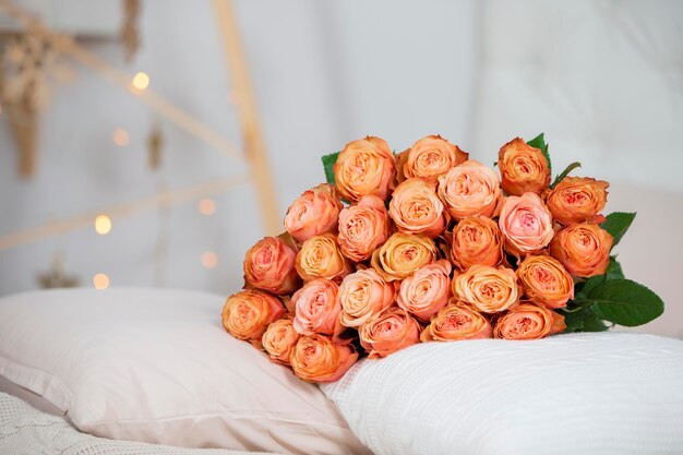 Un ramo de rosas yace sobre las almohadasRegalo para las vacaciones Ramo de rosas