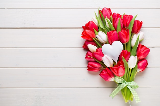 Ramo de tulipanes rojos en la madera blanca