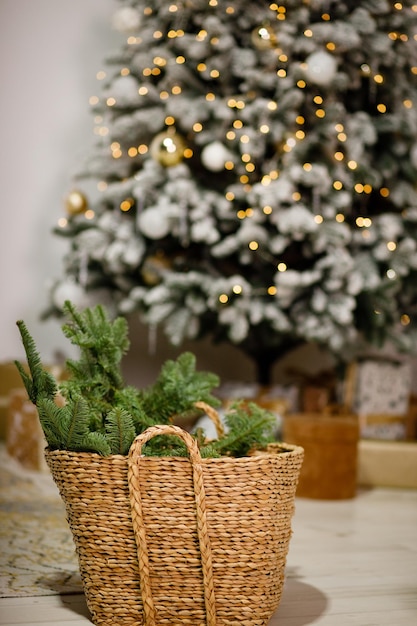 Ramos de uma árvore de Natal em uma cesta de vime no fundo