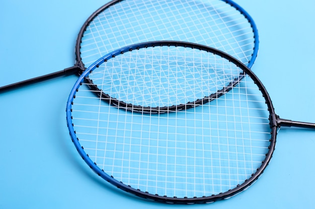 Raquetas de bádminton sobre fondo azul.