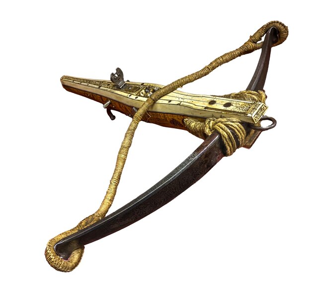 A rare and beautifully preserved antique crossbow is showcased in a detailed studio shot featuring