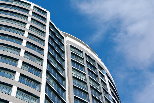 Rascacielos de oficinas edificio de negocios alto sobre fondo de cielo azul mirando hacia un edificio moderno de vidrio