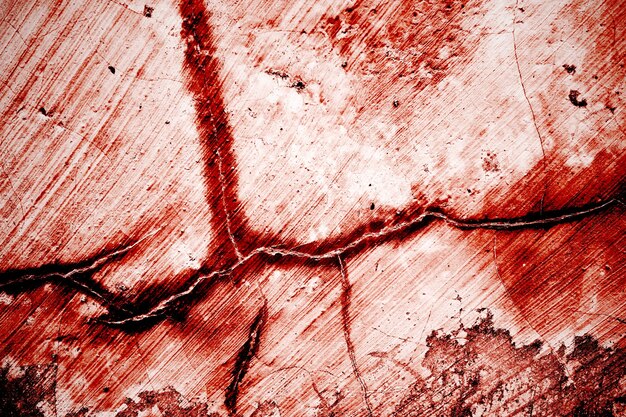 Rasguños rojos en la pared que se pueden usar como fondo de terror Pintura de sangre vieja y grietas de yeso