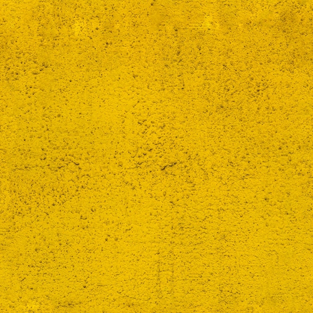 Raue gelb gestrichene Wandstruktur