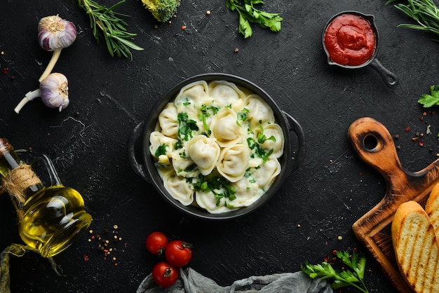 Ravioli con salsa de crema en un plato negro Cocina tradicional italiana Albóndigas de carne Vista superior Espacio de copia libre