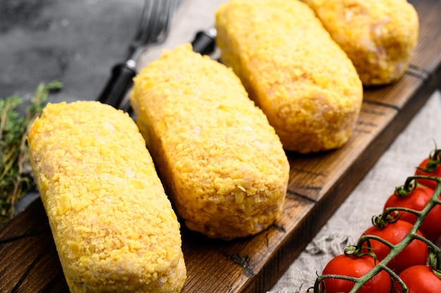 Raw Wiener Schnitzel, empanizado, sobre fondo de mesa de piedra gris