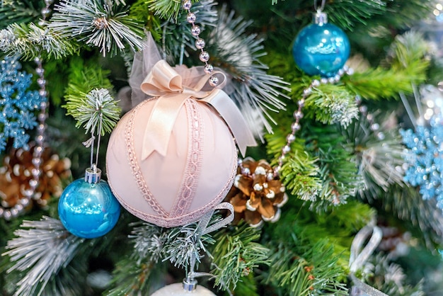 Árbol de Navidad con adornos coloridos, textiles juguetes de color rosa y azul, profundidad de campo