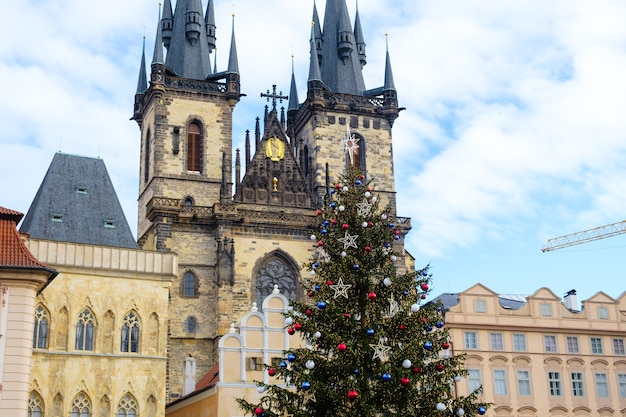 Árbol de navidad con bolas de colores en el casco antiguo de praga en el fondo de la iglesia de la madre